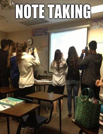 students using mobiles to photograph a presentation rather than taking notes